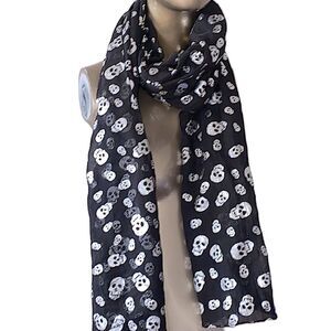 Black and silver skull scarf. Light weight and breezy, foilshiny silver skulls.